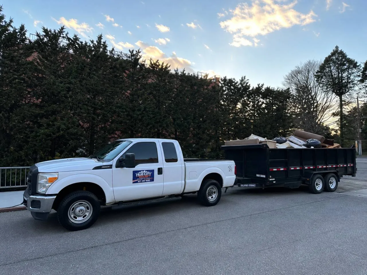 The Hub City Hauling truck and dump trailer on a Boston-area street